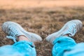Blue jean and white canvas shoes on grass field Royalty Free Stock Photo
