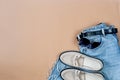 Blue jeans, beige suede loafer or flat shoes lying and sunglasses on beige background Royalty Free Stock Photo