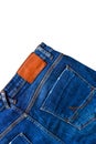 Blue jeans with blank leather label and back pockets on white background. Royalty Free Stock Photo