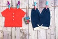 Blue jeans for a boy, a red shirt and a toy train on a clothesline Royalty Free Stock Photo