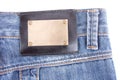 Blue jeans with bronze label. Isolated