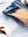 Blue jeans with a brown leather blank label, close-up. Jeans texture. Fashion denim background for sewing, copy space Royalty Free Stock Photo