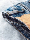 Blue jeans with a brown leather blank label, close-up. Jeans texture. Fashion denim background for sewing, copy space. Label on Royalty Free Stock Photo