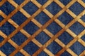 Blue jeans denim and gold fabric texture background with crosshatching or rhombuses.