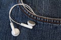 Blue jeans with earbud from its pocket