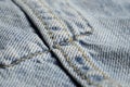 Blue jeans fabric macro seam pattern blurred background. Denim background texture for design. Royalty Free Stock Photo