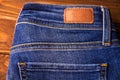 Blue jeans with half of back pocket and brown leather tag Royalty Free Stock Photo