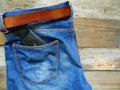 blue jeans with leather belt and a black purse in the back pocket Royalty Free Stock Photo