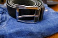 Blue jeans with leather black belt and metal silver-colored buckle close-up. Male casual fashion. Store display. Accessories Royalty Free Stock Photo