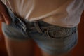 Blue jeans shorts and a T-shirt on a girl, closeup view Royalty Free Stock Photo