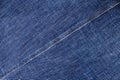 Blue jeans texture, diagonal seam closeup, thread stitch line, jean textile background, dark blue denim backdrop, jeans pattern Royalty Free Stock Photo