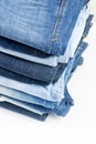 Blue jeans trousers stack on white background Royalty Free Stock Photo