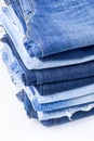 Blue jeans trousers stack on white background Royalty Free Stock Photo