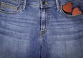 Blue jeans and two red wooden hearts Royalty Free Stock Photo