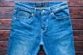 Blue jeans on a wooden background close up Royalty Free Stock Photo