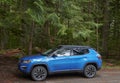 Blue Jeep Compass parked at trailhead