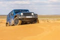 Blue Jeep Wrangler Rubicon Unlimited at desert sand dunes Royalty Free Stock Photo