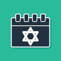 Blue Jewish calendar with star of david icon isolated on green background. Hanukkah calendar day. Vector