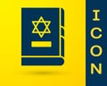 Blue Jewish torah book icon isolated on yellow background. On the cover of the Bible is the image of the Star of David