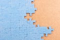 Blue jigsaw puzzle on brown background with copy space. Connected blank puzzle pieces