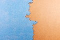 Blue jigsaw puzzle on brown background with copy space. Connected blank puzzle pieces