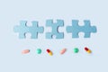 Blue jigsaw puzzle pieces with different pills and medicines. Concept of Neurological Disease Treatment : Autism, Alzheimer`s,