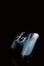 A blue joystick from a game console on a black background