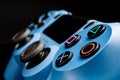A blue joystick from a game console on a black background