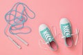 Blue jump rope and sneakers on the wooden floor. Sports style. Flat lay. Royalty Free Stock Photo