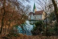 Blue karst spring `Blautopf` with the hammermill and the Blaubeuren Abbey Royalty Free Stock Photo