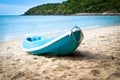 Blue kayak on sandy beach