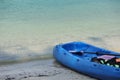 Blue Kayak on the tropical white sand beach with sea waves. Scenic relaxing scenery