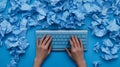 Blue Keyboard and Crumpled Paper Hands typing on a blue keyboard surrounded by crumpled blue paper Concept of writing editing