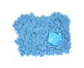 Blue kinetic sand and toy on white background, top view Royalty Free Stock Photo