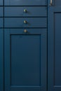 Blue kitchen cabinet with three drawers and brass knobs. Color mood. Royalty Free Stock Photo