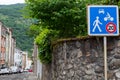 Blue 20km h Home Zone speed limit sign showing car, bicycle and pedestrian in French street