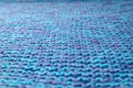 Blue knitted background. Knitted texture. A sample of knitting. Knitting Pattern.