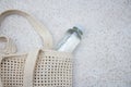 Blue knitted bag handmade and a bottle of water outdoors. Sustainable shopping. Waste-free lifestyle Royalty Free Stock Photo