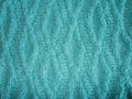 Blue knitted texture with a rhomb pattern