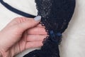 Blue lace bra in female hand. Fashion lingerie concept. Close up Royalty Free Stock Photo