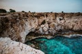 A blue lagoon in Cape Greco, Cyprus. The water has many shades of blue. Crystal clear water. Sharp rocks emerging from
