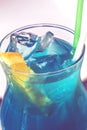 Blue lagoon cocktail with blue curacao liqueur, vodka, lemon juice and soda, decorated with orange slice Royalty Free Stock Photo