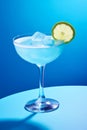blue lagoon cocktail drink in cocktail glass on blue background Royalty Free Stock Photo