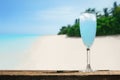 Blue lagoon alcoholic cocktail. Glass of summer cocktail on tropical beach bar. Royalty Free Stock Photo
