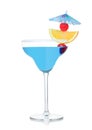 Blue lagoon cocktail in margarita glass with orange slice and sweet cherry with umbrella on white Royalty Free Stock Photo