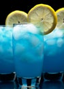 Blue lagoon cocktails with slice of lemon isolated on black Royalty Free Stock Photo