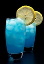 Blue lagoon cocktails with slice of lemon isolated on black Royalty Free Stock Photo