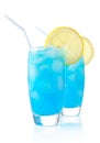 Blue lagoon cocktails with slice of lemon with straw isolated on white Royalty Free Stock Photo