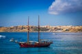 Blue Lagoon, Malta - Old sailing boat at the Island of Comino next to the famous Blue Lagoon with the Island of Gozo Royalty Free Stock Photo