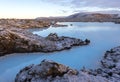Blue lagoon waters at winter in Iceland. Volcanic formations filled with white-blue warm water